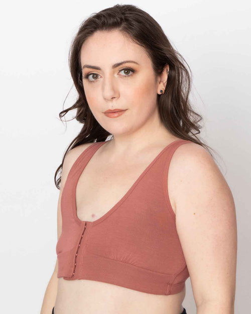 Dusty Rose / Mastectomy & pocketed front closure bra with soft wire free cups and adjustable straps on mastectomy model wearing breast forms front view