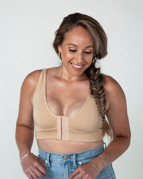 Sand / Implants & pocketed front closure bra with soft wire free cups and adjustable straps on implant model racerback view