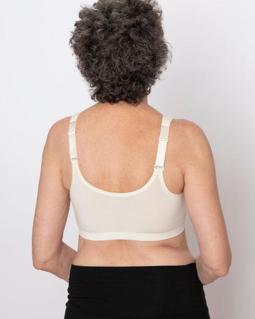 Ivory / Flat & pocketed front closure wire free bra with adjustable straps on flat model back view