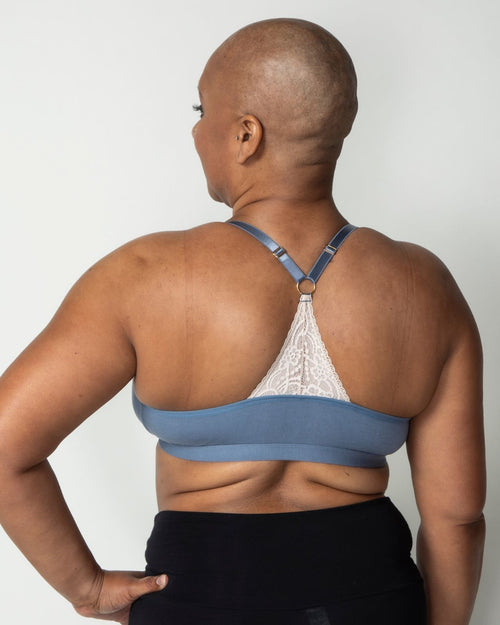 Slate / Mastectomy & pocketed front closure lace racerback bra with a plunging neckline and soft wire free cups on mastectomy model with breast forms.
