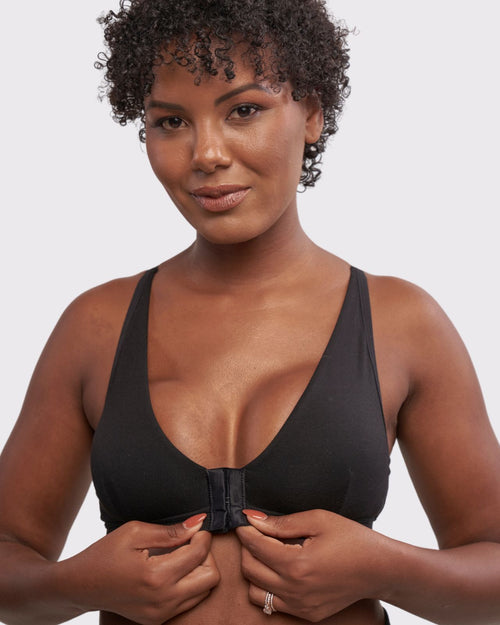 Slate / Implants & pocketed front closure lace racerback bra with a plunging neckline and soft wire free cups on implant reconstruction model.