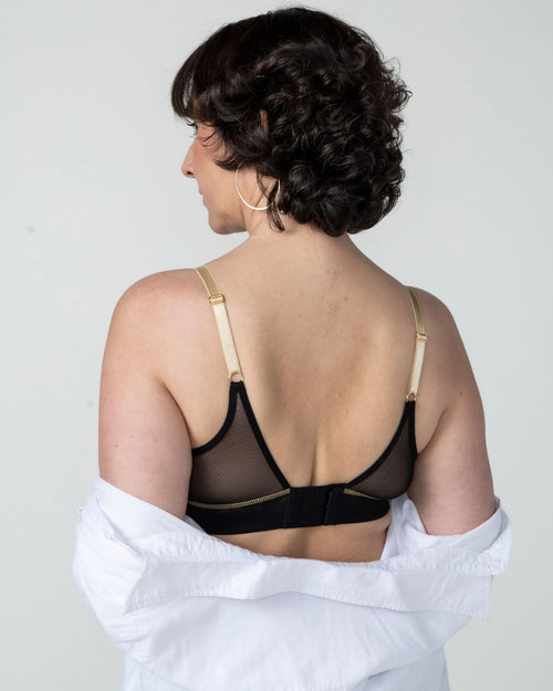 Black / Flap Reconstruction & model wearing the Victoria Pocketed Keyhole bralette with gold lace trim and gold jewel that says anaono